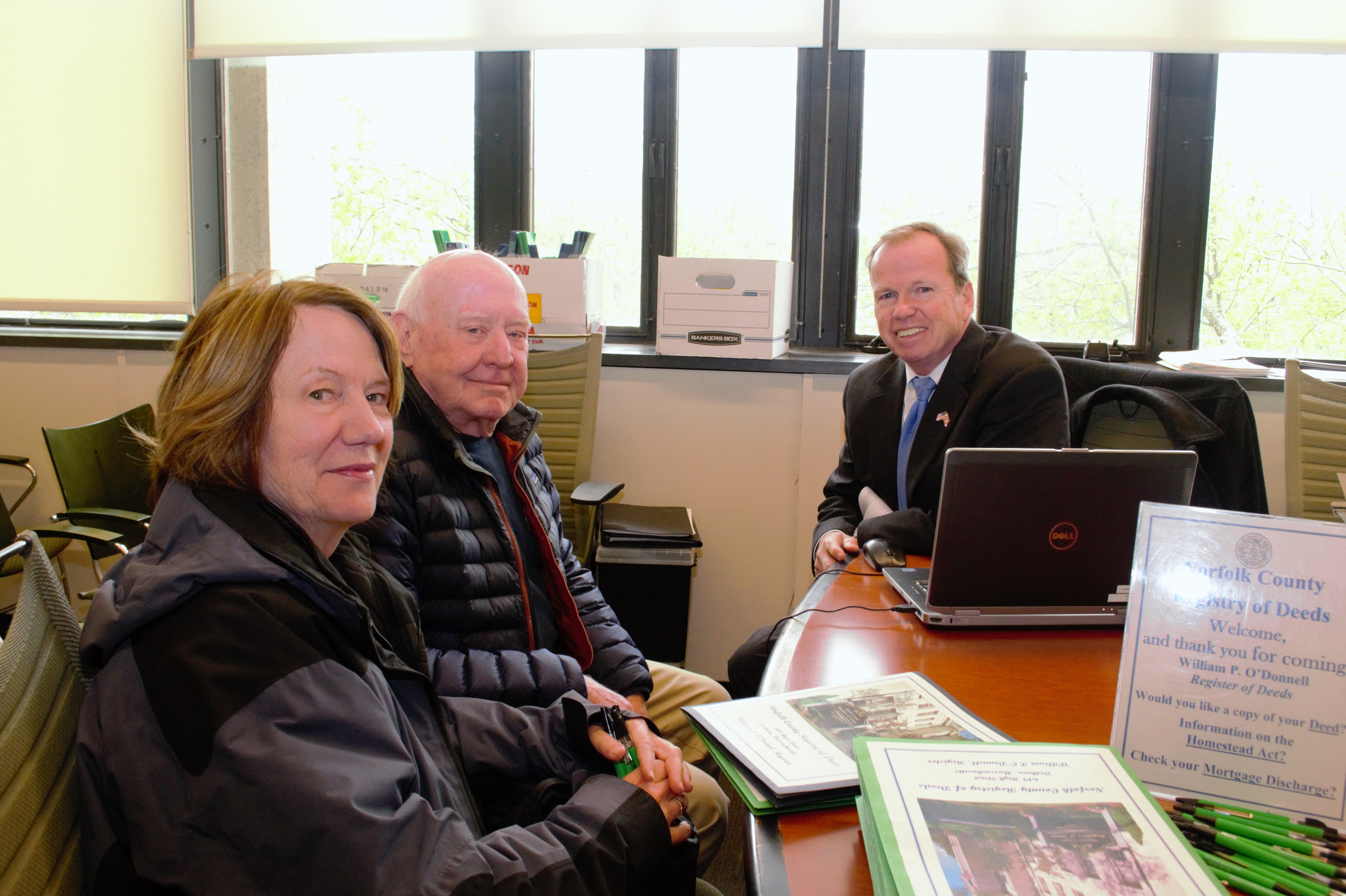 (From right) Norfolk County Register of Deeds William P. O’Donnell, Gerard and Margaret Lloyd pose for a photo during the Registry of Deeds office hours at Milton Town Hall.