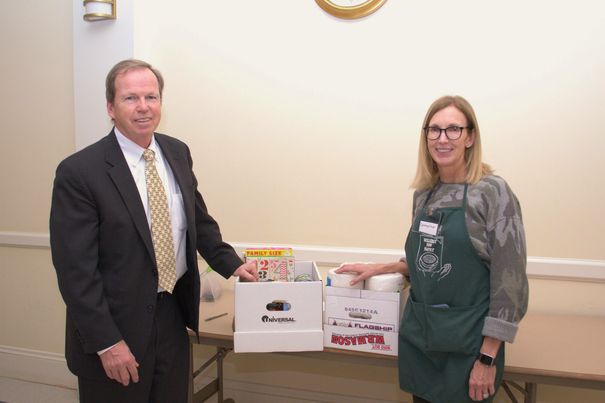 Register of Deeds William P. O’Donnell delivers food donations collected during the Registry of Deeds Annual Holiday Food Drive to Catherine Russell, Wellesley Food Pantry Board Member.